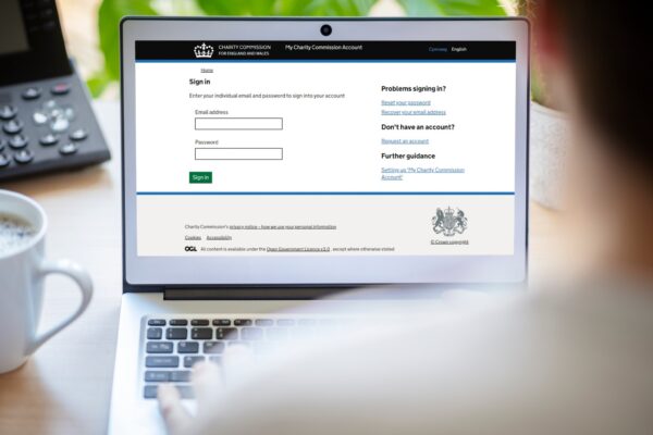 A person logs on to their My Charity Commission Account using a laptop